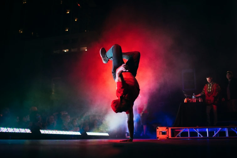 man doing breakdancing on gray surface